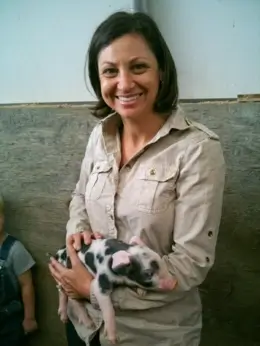 Ganzler holds a piglet.