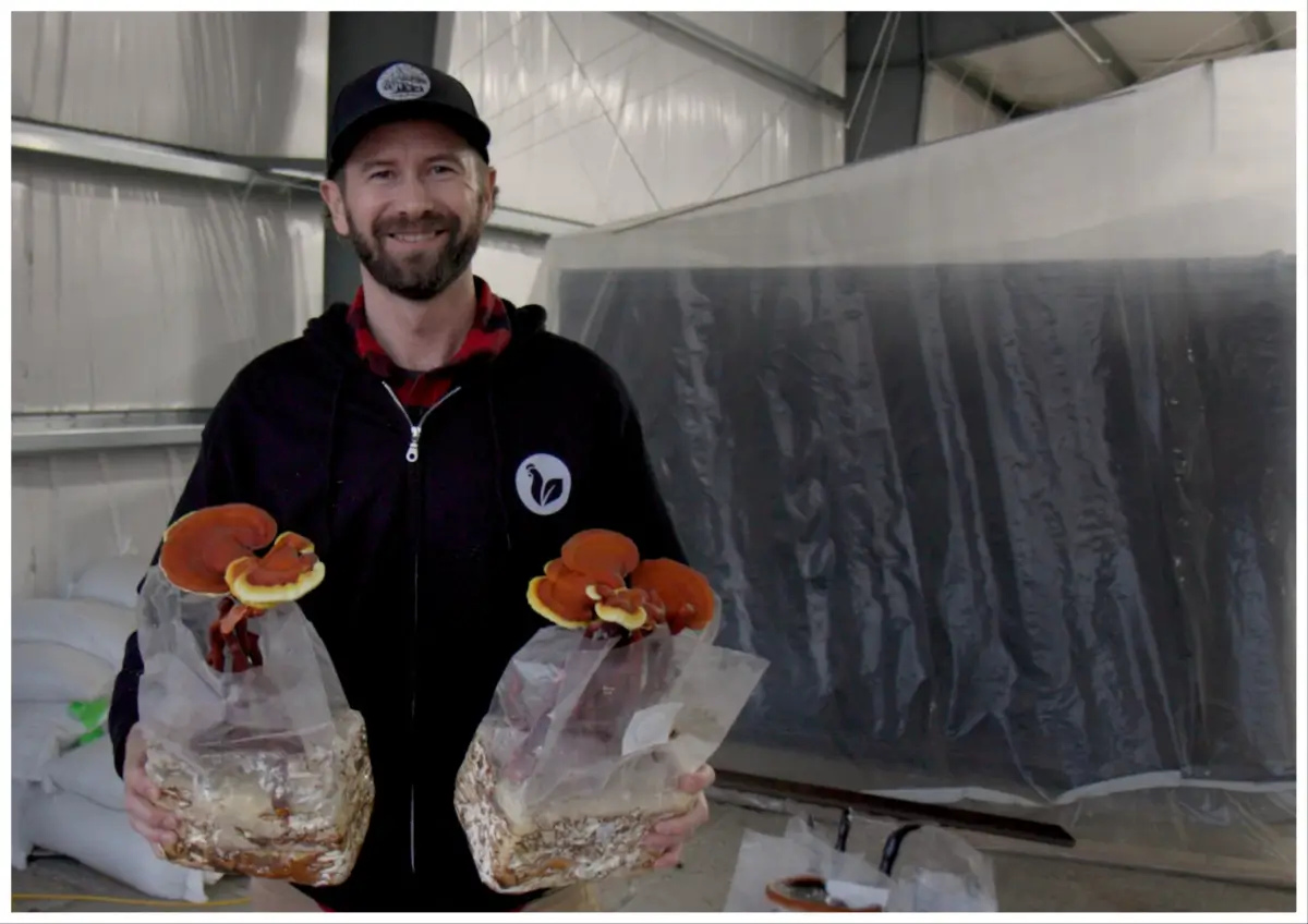 Tanner Faaborg holding mushrooms.