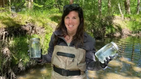 Emily Sutton holds sampling jars.